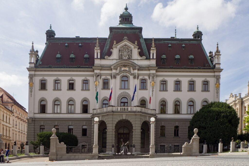 a large building with flags on the roof